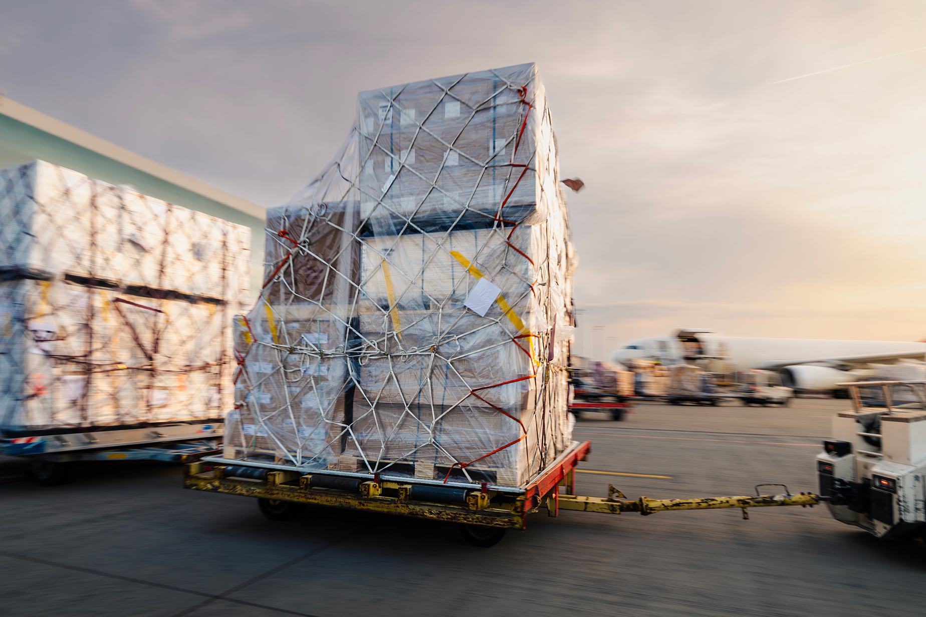 cargo-carts-with-freight-in-motion-blur-moving-tow-2026-03-12-15-04-30-utc