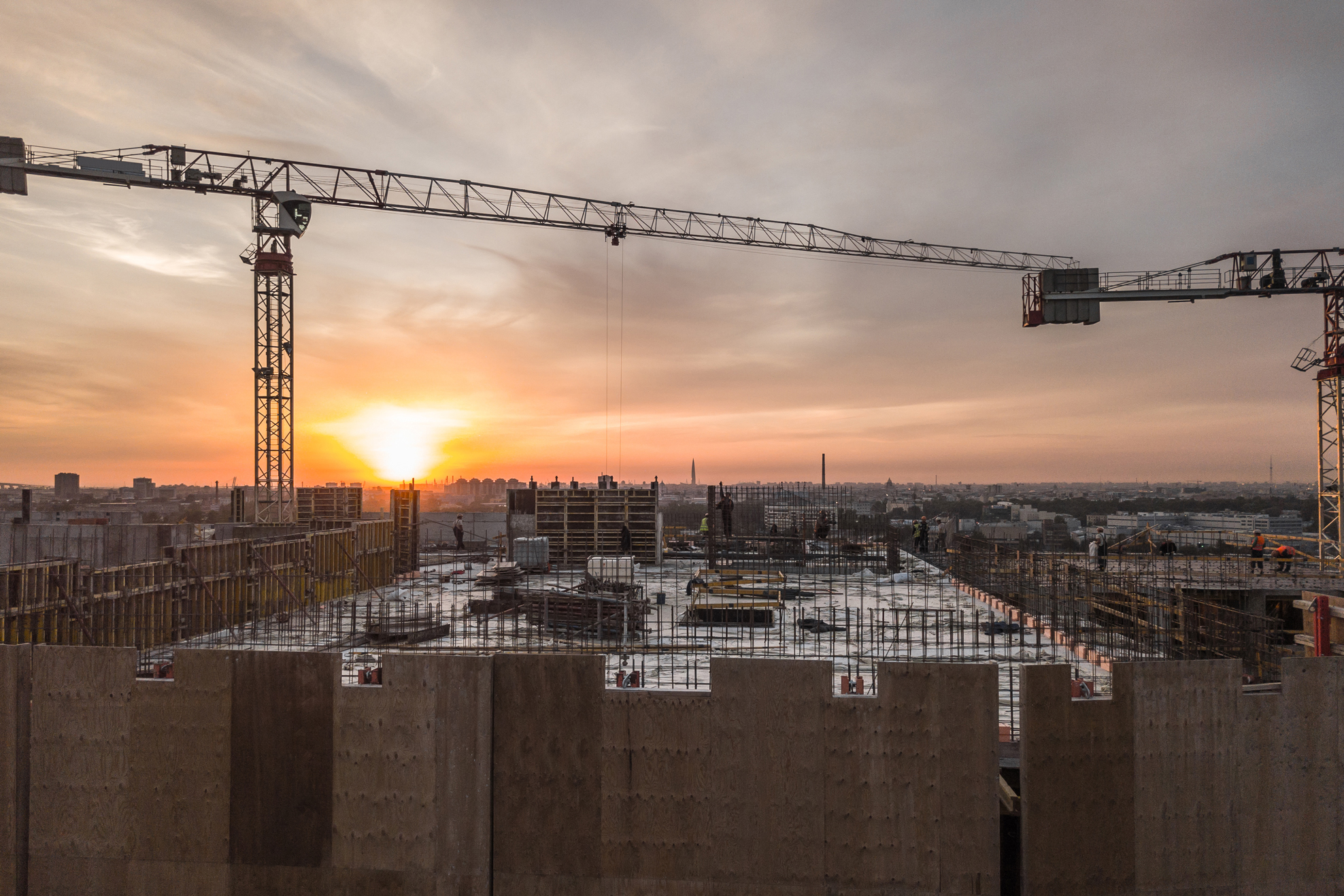 construction-cranes-overlooking-city-at-sunset-2026-09-23-04-51-57-utc