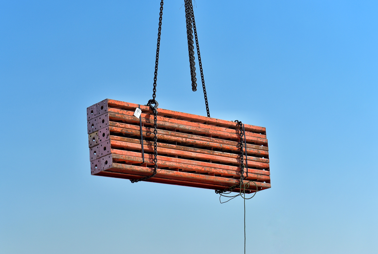 construction-materials-lifted-by-chains-against-bl-2026-09-23-23-21-12-utc
