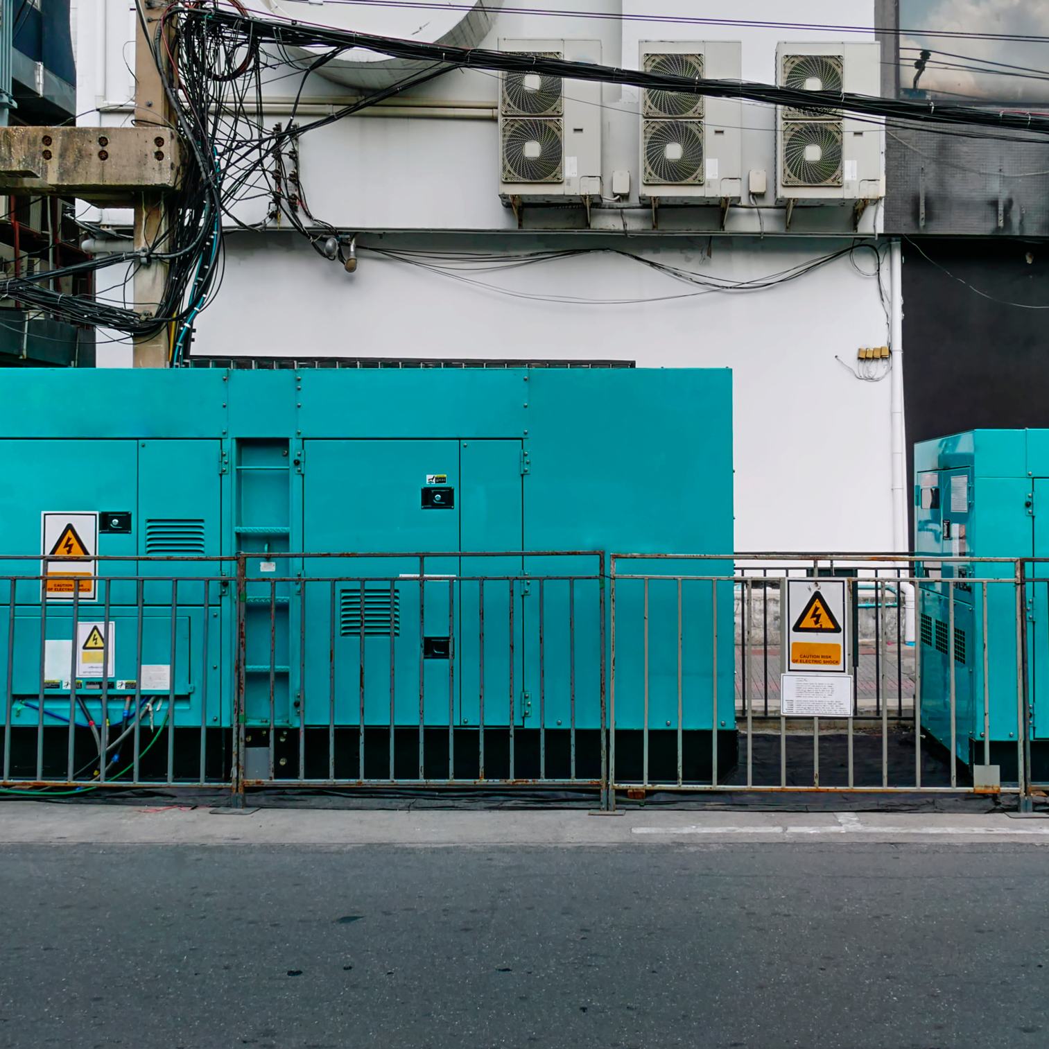 large-teal-generators-behind-fence-urban-setting-2026-09-24-02-50-39-utc