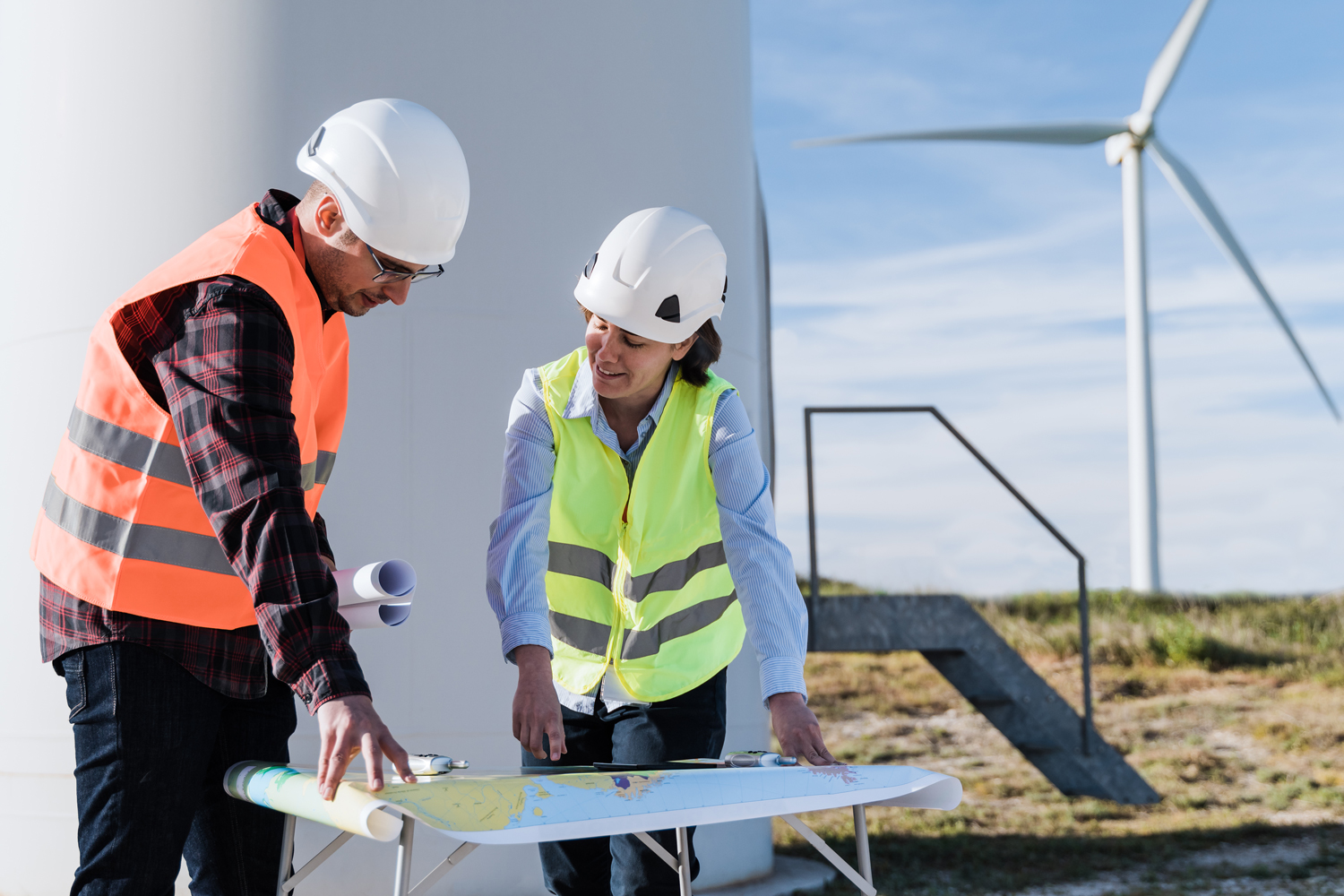 engineers-analyzing-plans-at-wind-turbine-farm-2026-09-23-18-10-46-utc
