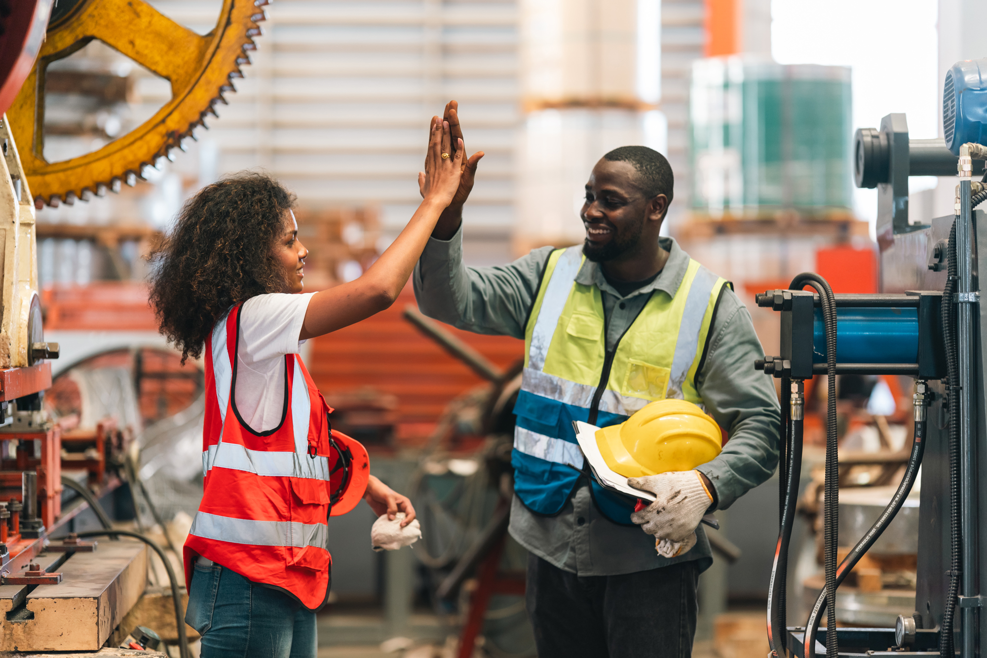 smiling-factory-workers-giving-a-high-five-2026-09-22-03-09-42-utc