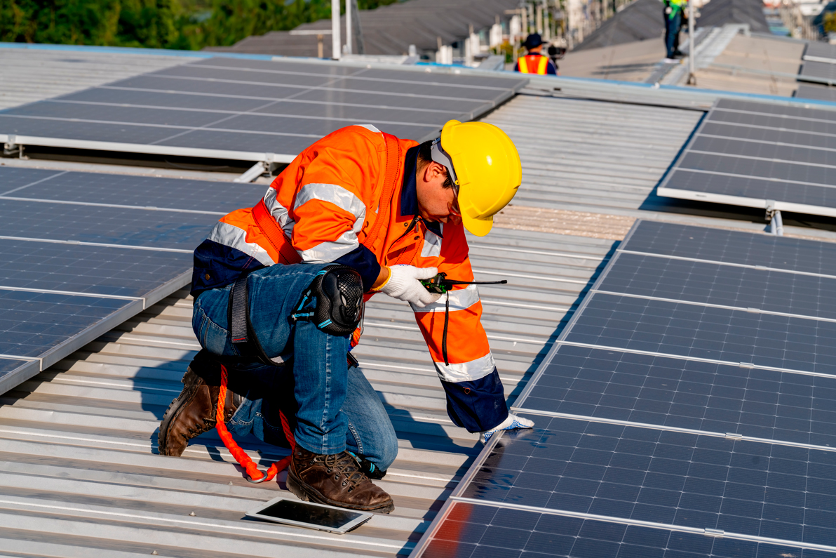 technician-installing-solar-panels-on-building-roo-2026-09-23-11-43-48-utc