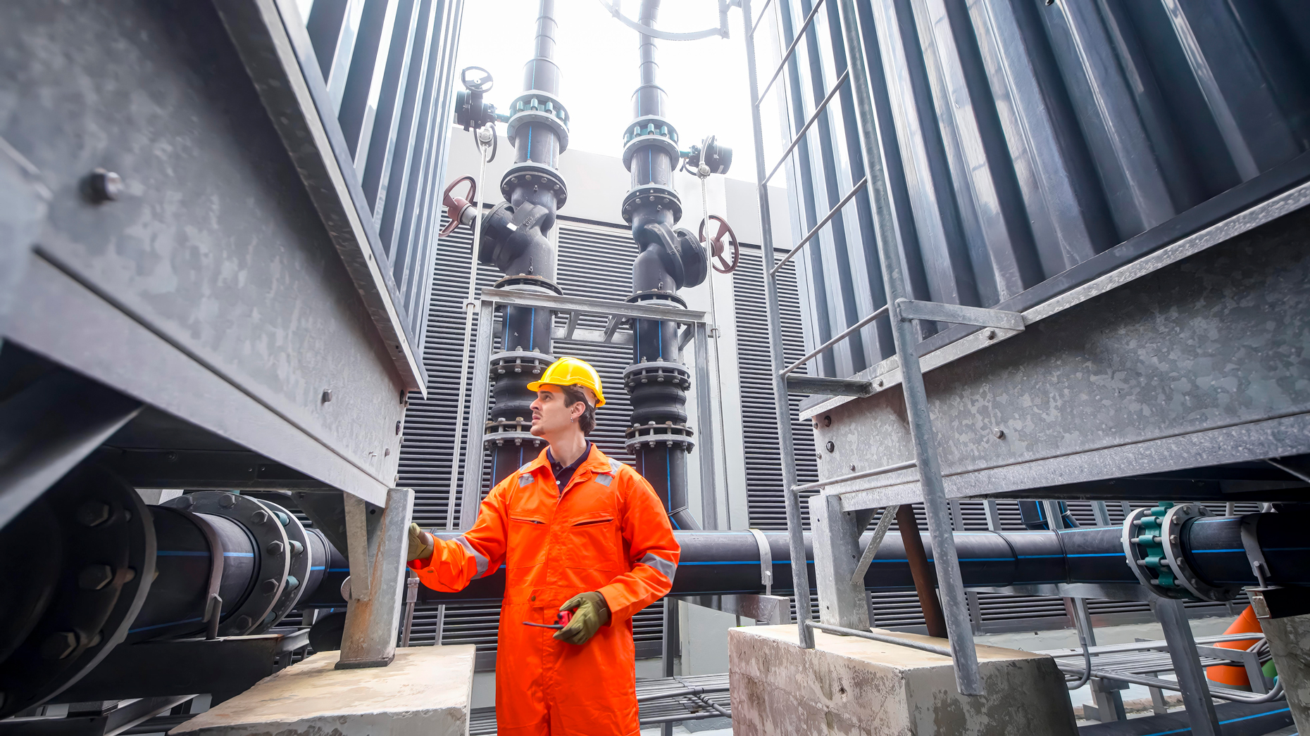 worker-inspecting-piping-system-at-industrial-site-2026-09-24-13-25-05-utc